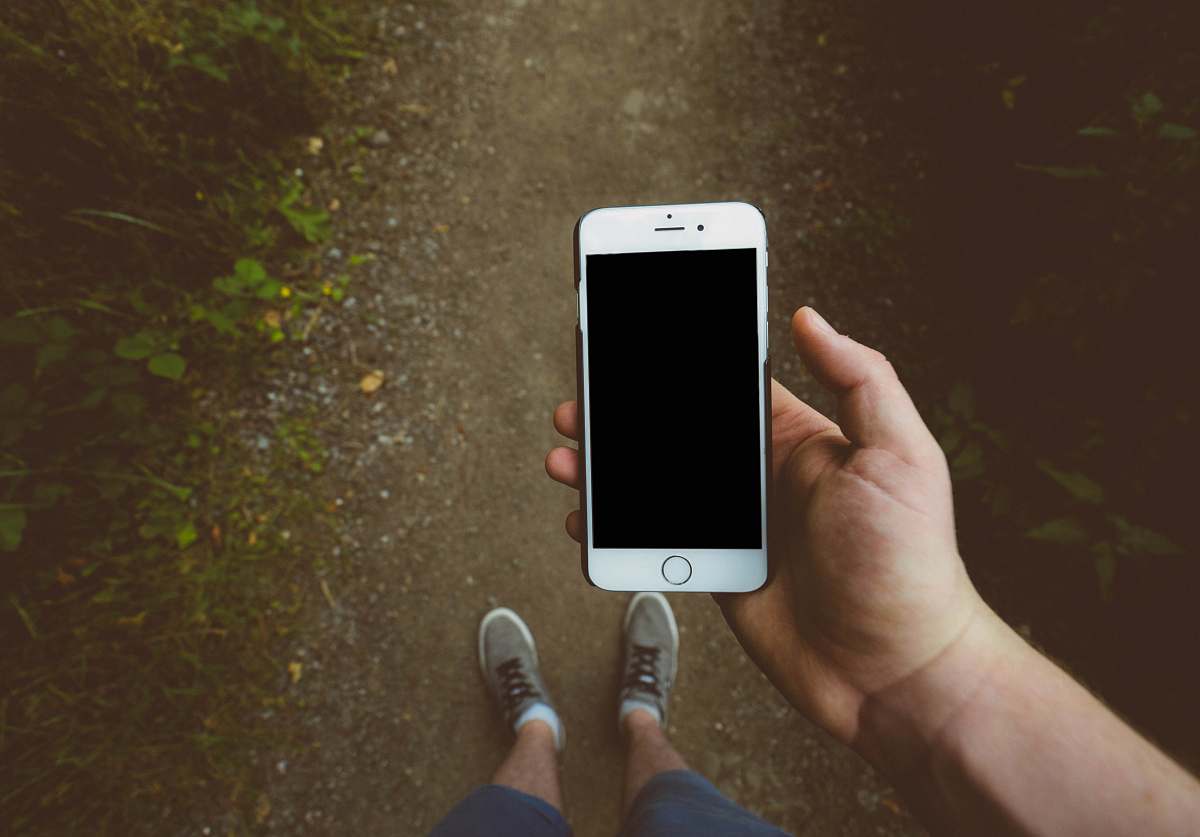 mobile phone person holding silver iPhone 6 with black case smartphone